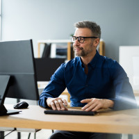 ABRID man with glasses on computer 407968477 Web
